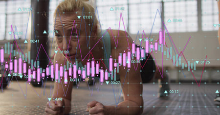 Animation of financial graphs over happy diverse female and male warehouse workers