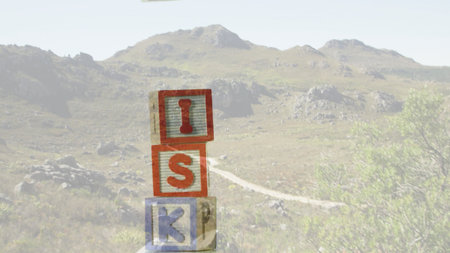 Showing stacked wooden blocks spelling ISK on winding dirt path in flat design for education theme. Children's toys, educational materials, playful design, outdoor landscape, natural setting, learning tools, minimalist styleの写真素材