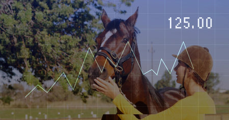 Holding bay horse bridle, rider in brown helmet yellow top standing in paddock with grid 125.00....