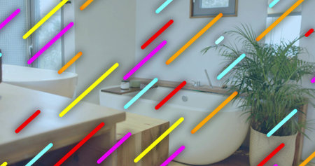 Showing freestanding white oval bathtub sitting at right in bathroom, with potted palm and vanity....
