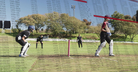 Standing batter in red shirt holding bat at park, wicket-keeper crouching with pink stumps overlay. Cricket, field, pitch, crease, umpire, outdoor, floodlightの写真素材