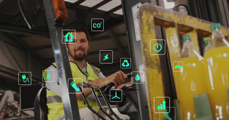 Operating adult wearing hi-vis vest handling forklift controls at depot, with pallet yellow bottles....