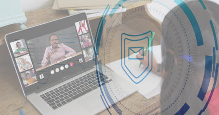 Showing laptop running meeting with tiles and casual clothing on desk, with notes, shield HUD....