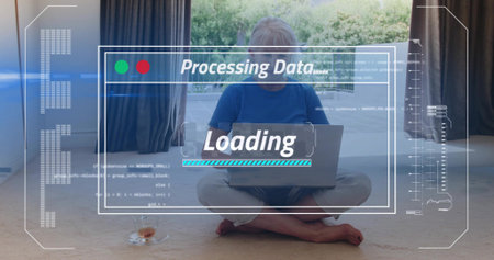 Sitting senior woman wearing blue shirt and light pants using laptop at home, with HUD overlays....
