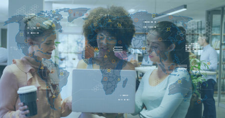 Gathering three coworkers reviewing laptop in modern office, holding cup, showing data overlay....