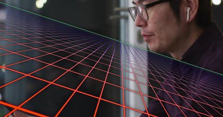 Checking smartphone Asian man in dark shirt, glasses and earbud by window, neon grid, copy space....