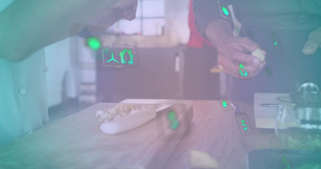Preparing garlic on wooden board in kitchen, chef jacket red apron hands showing green AR icons....