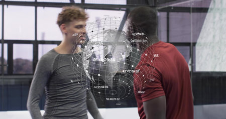 Analyzing two men wearing gray top and red shirt studying holographic globe in training studio....