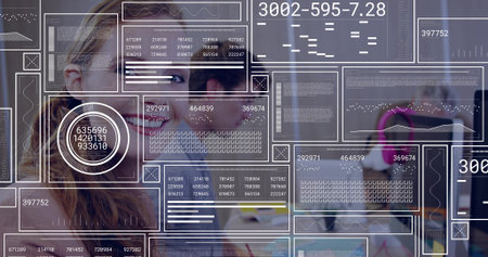 Smiling woman wearing casual top viewing AR HUD on monitors in open office, with pink headset....