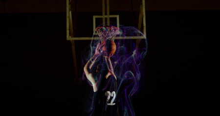 Dunking basketball player powering ball through hoop at gym wearing jersey 22 with purple smoke....