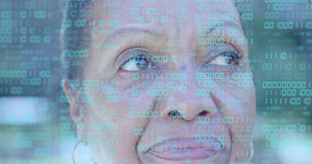 Gazing senior Black woman looking up-left in studio, reflecting binary overlay and hoop earring....