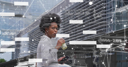 Sipping woman in gray sweater on sidewalk near metal wall holding phone bottle earbuds data overlay....
