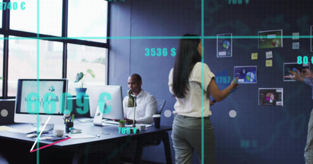 Pointing woman in white blouse, light-gray trousers interacting with charts and monitors at office....