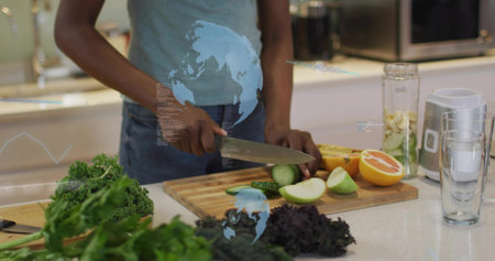 Slicing woman in light blue top preparing cucumber on cutting board, with chef's knife and blender....