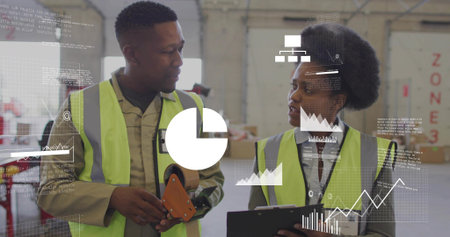 Checking two staff in safety vests comparing inventory data in packing bay with tape, clipboard....