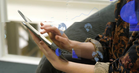 Swiping seated woman wearing patterned top rolled cuffs holding tablet near window with data graphs....
