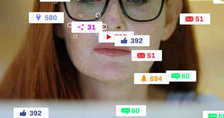 Peering mature redhead woman scrolling laptop at home, wearing round glasses, top with social icons....