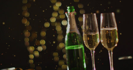 Displaying green champagne bottle and two flutes with rising bubbles on bar tabletop, bokeh....