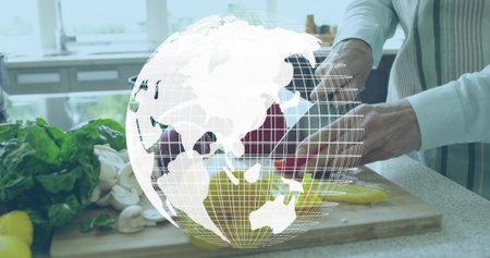Slicing red pepper, cook in striped apron making salad in kitchen with knife, globe overlay. Woman, vegetables, chopping, cuttingboard, sunlit, domestic, brightの写真素材
