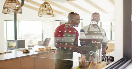 Planning two men wearing aprons reviewing schedule at kitchen island, with tablet and calendar UI....
