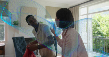 Man wearing light shirt watch holding red garment, woman pink shirt gesturing at home, hologram....