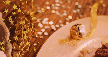 Sitting gold jingle bell on white plate at wooden table, pastry and star confetti, copy space....