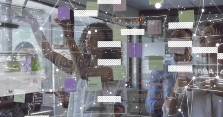 Working team at office in shirts moving purple green sticky notes on glass board, annotating data....