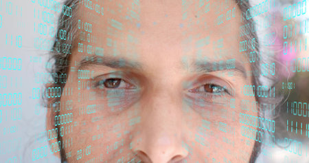 Staring mid-adult Indian man showing eyes and beard in studio close-up, with teal binary overlay....