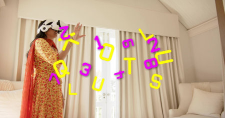 Woman wearing VR headset in floral tunic red scarf interacting with symbols at home, copy space....