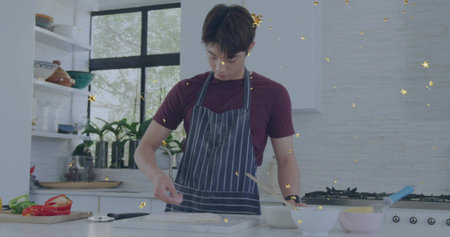 Shaping dough teen Korean wearing maroon-tee navy-striped-apron in home-kitchen, with marble slab....