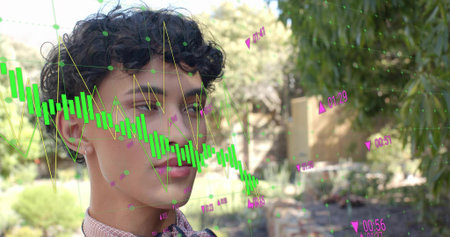 Standing male with curly hair wearing patterned shirt and bow tie in garden, showing data overlay. Man, backyard, greenery, bamboo, shrubs, sunny, chartの写真素材