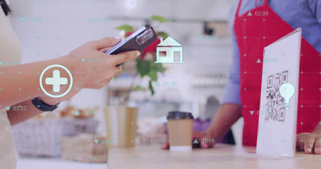 Holding smartphone, customer hands tapping QR code stand at cafe counter, barista wearing red apron....