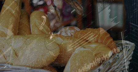 Reaching hand holding metal tongs selecting bread in bakery display. Loaves, basket, rustic,...