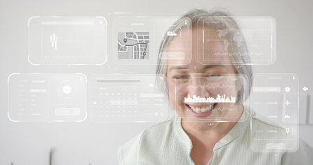 Smiling mature Asian woman wearing pale green blouse viewing HUD panels in small office. Overlay,...