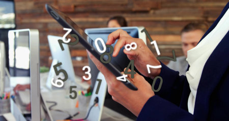 Interacting woman dark blazer white blouse using tablet with digit overlay at office, copy space....