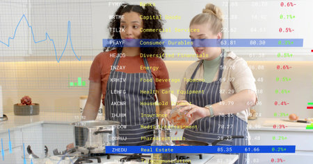 Mixing two women wearing striped aprons preparing meal in kitchen with glass bowl, stock ticker....