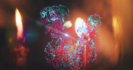 Glowing cluster of cyan-magenta particles surrounding two lit candle flames in dim room, with bokeh....