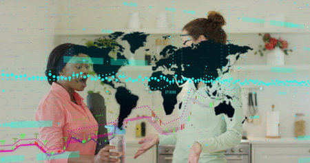 Talking women in kitchen, wearing pink and green tops, holding glass, cylinder with map overlay....