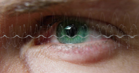 Showing human eye gazing outward and filling frame in studio, with green iris, sine-wave overlay....