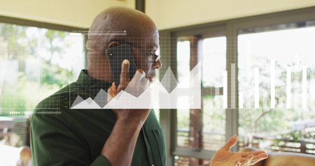 Talking man wearing dark green shirt, glasses, holding phone, gesturing in home, data overlay....