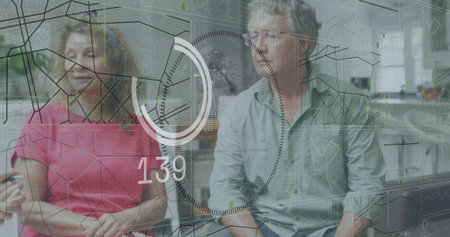 Sitting couple in lounge, woman in pink holding cup, man wearing glasses viewing overlay 139. Duo,...