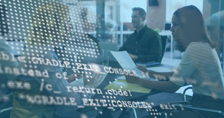 Discussing team wearing striped shirt, consulting papers and laptop in office with code overlay....