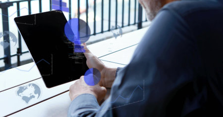 Holding man tapping tablet on deck showing data overlays wearing blue shirt wristwatch, copy space....