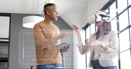 Demonstrating team in tan sweater, blazer using white VR headset, tablet with AR overlays in office....