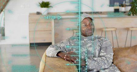 Leaning soldier wearing camo uniform and cap on beige sofa in living room, teal overlay. Camouflage,...