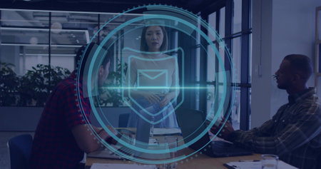 Leading Asian woman wearing sleeveless standing in glass meeting room with digital shield, laptops....