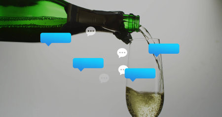 Pouring green glass bottle tipping sparkling liquid into flute glass studio, with blue chat bubbles....