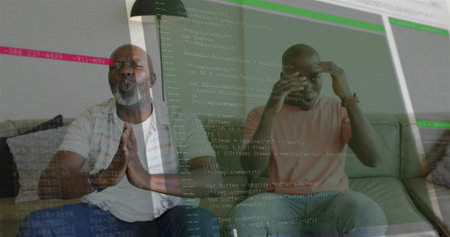 Reacting men in plaid, peach tee pressing palms holding forehead at home with code overlay, watch. Programming, ui, couch, livingroom, focus, concentration, casualの写真素材