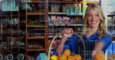 Smiling clerk wearing apron holding wicker-basket of oranges in shop with rack, copy space. Grocery,...