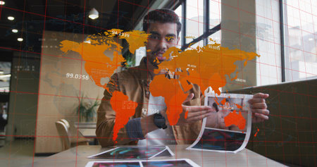 Presenting male in brown jacket holding and pointing printed sheets in office, with AR map overlay....